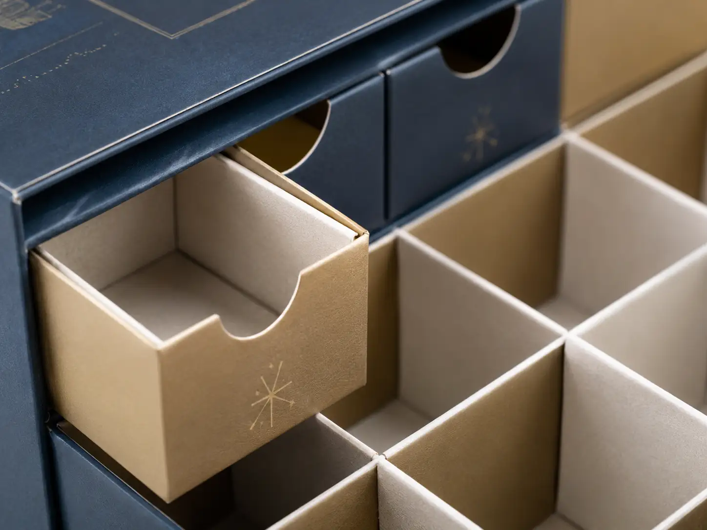 Macro detail of drawer compartments and paperboard dividers for a custom advent calendar box dieline.