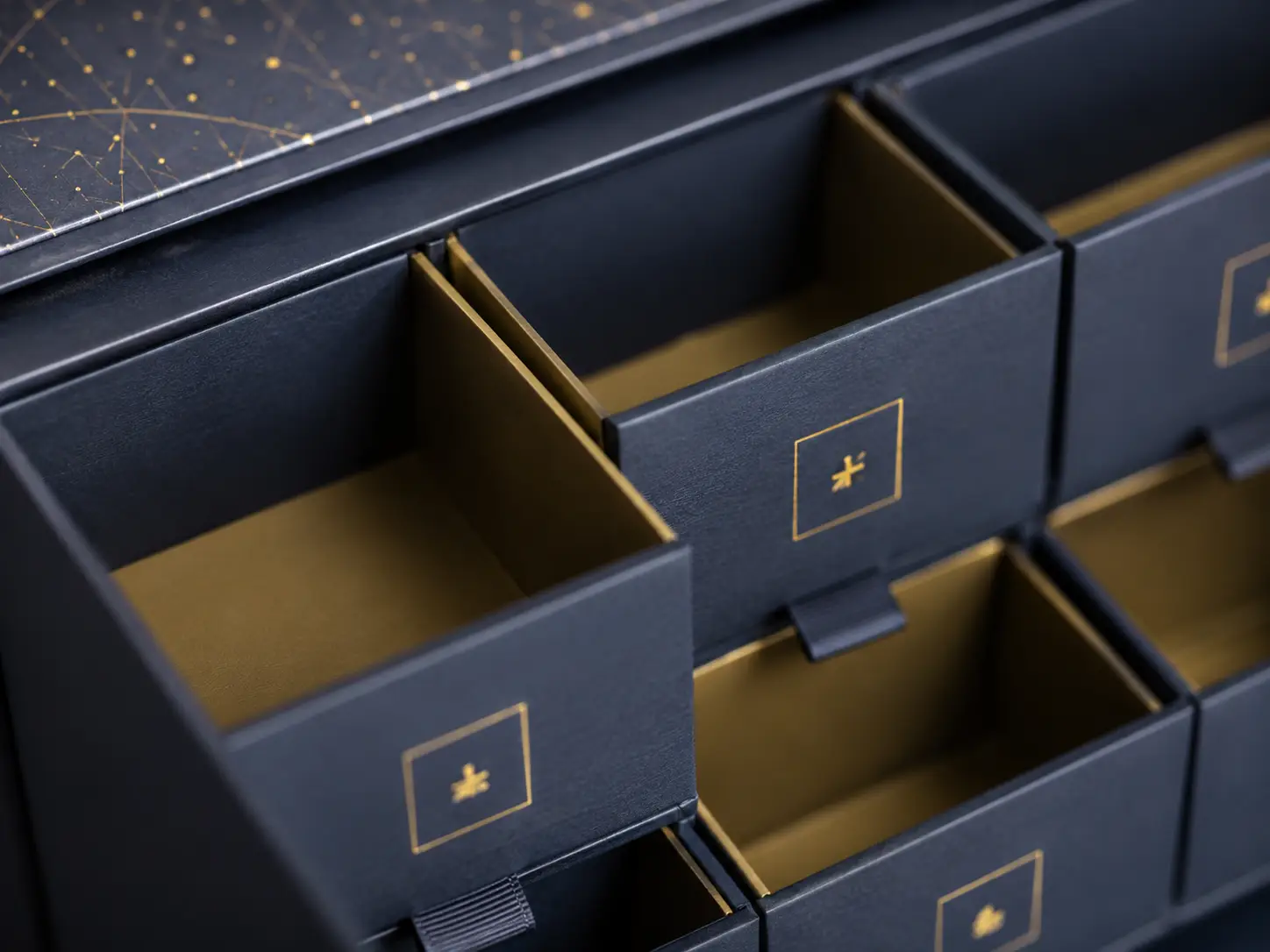 Macro detail of drawer compartments and paperboard dividers for rigid advent calendar boxes