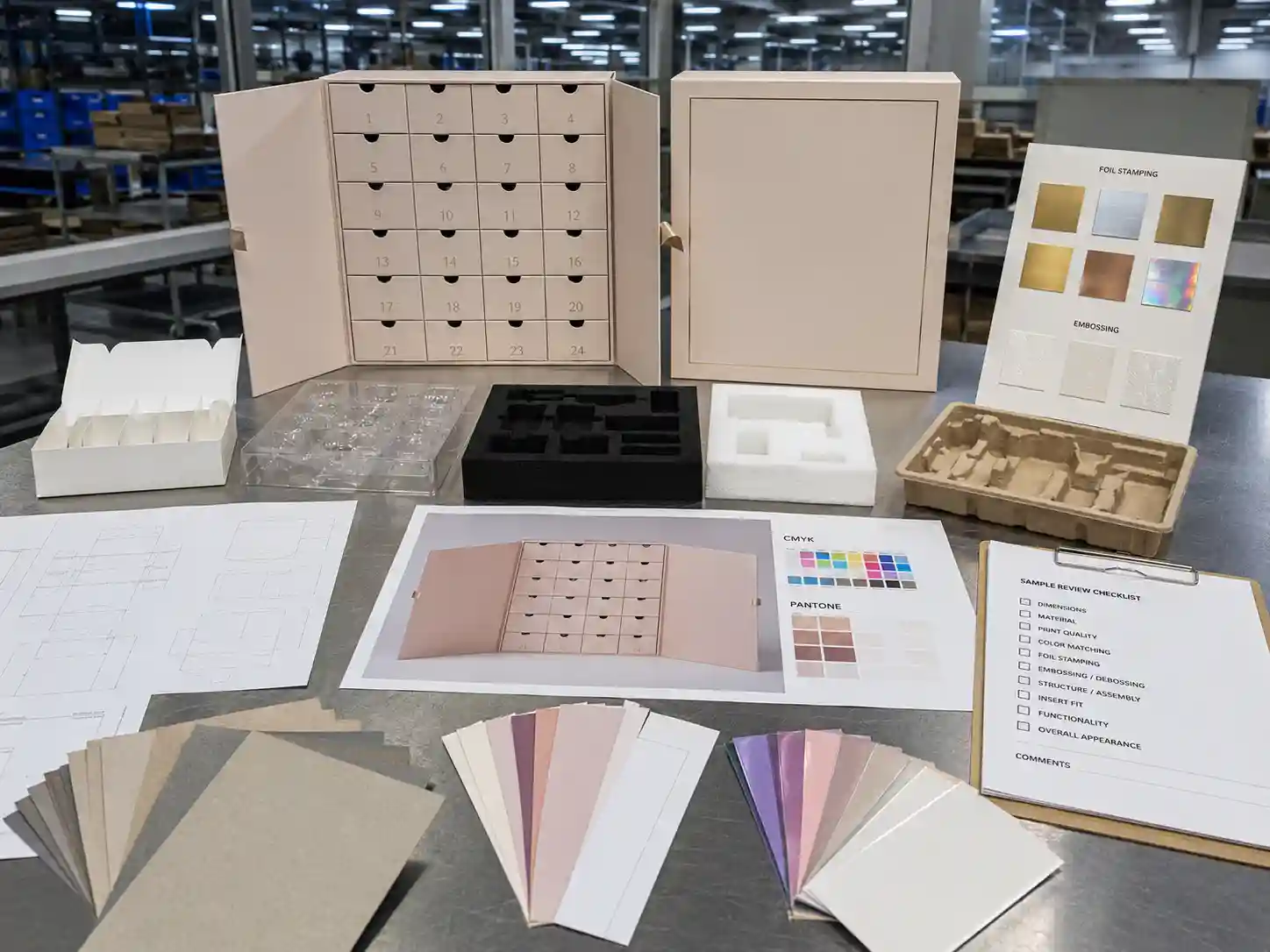 Factory planning table for beauty advent calendar boxes with dielines material swatches inserts and artwork proof