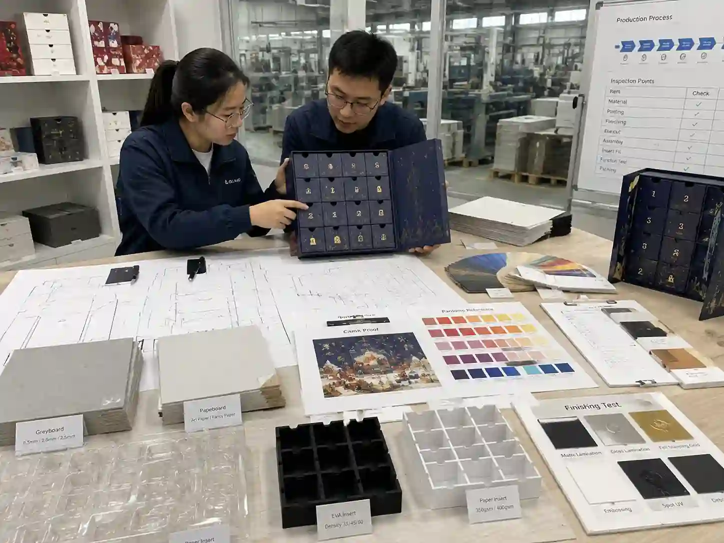 Packaging development table with samples and materials used to verify advent calendar box manufacturing