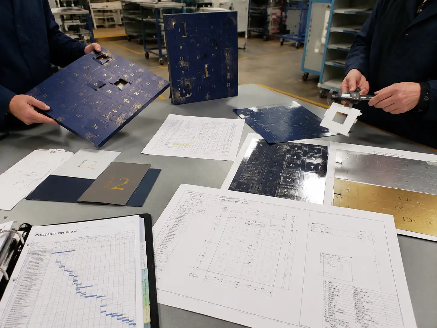 Packaging engineers testing foil registration alignment around advent calendar door cuts and numbered panels