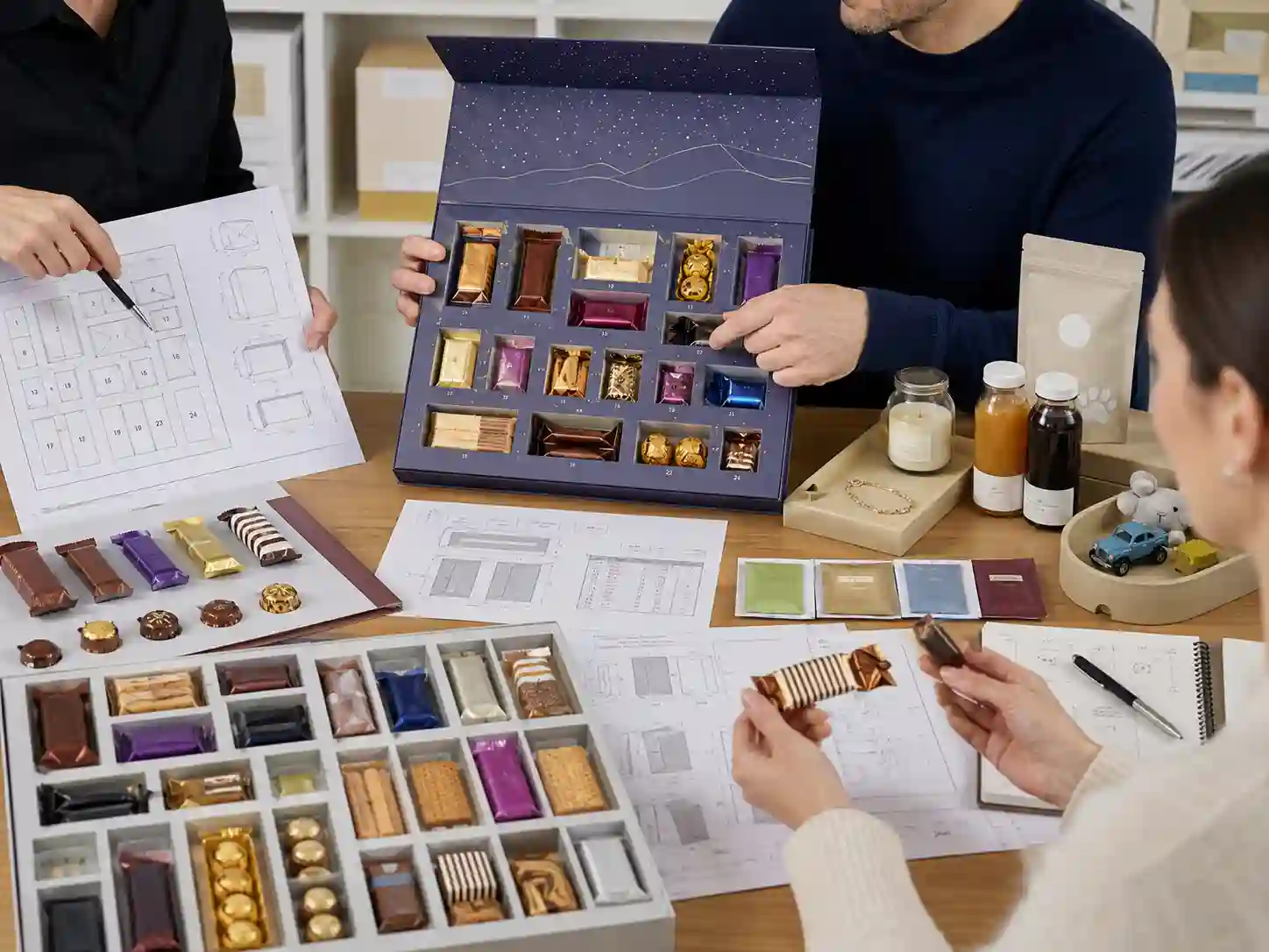 Packaging specialists review paper insert cavity fit for individually wrapped confectionery.