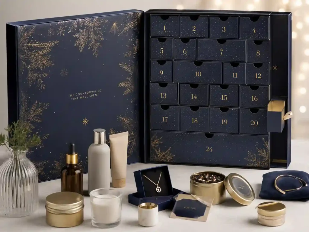 Premium advent calendar gift set retail presentation with cosmetic samples, candles, tea items, and custom paper inserts